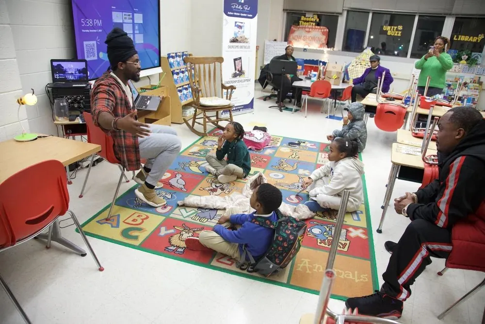Community members and young people working together around a table