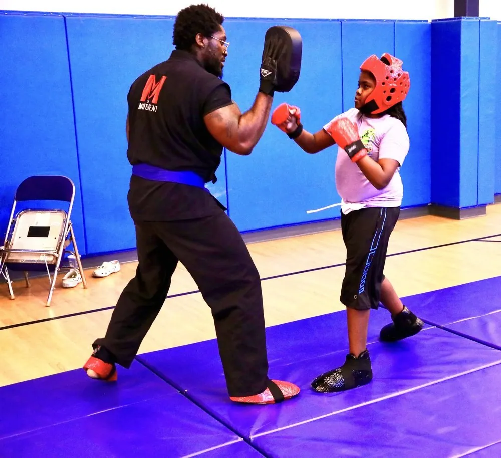 A mentor and young martial artist practicing together