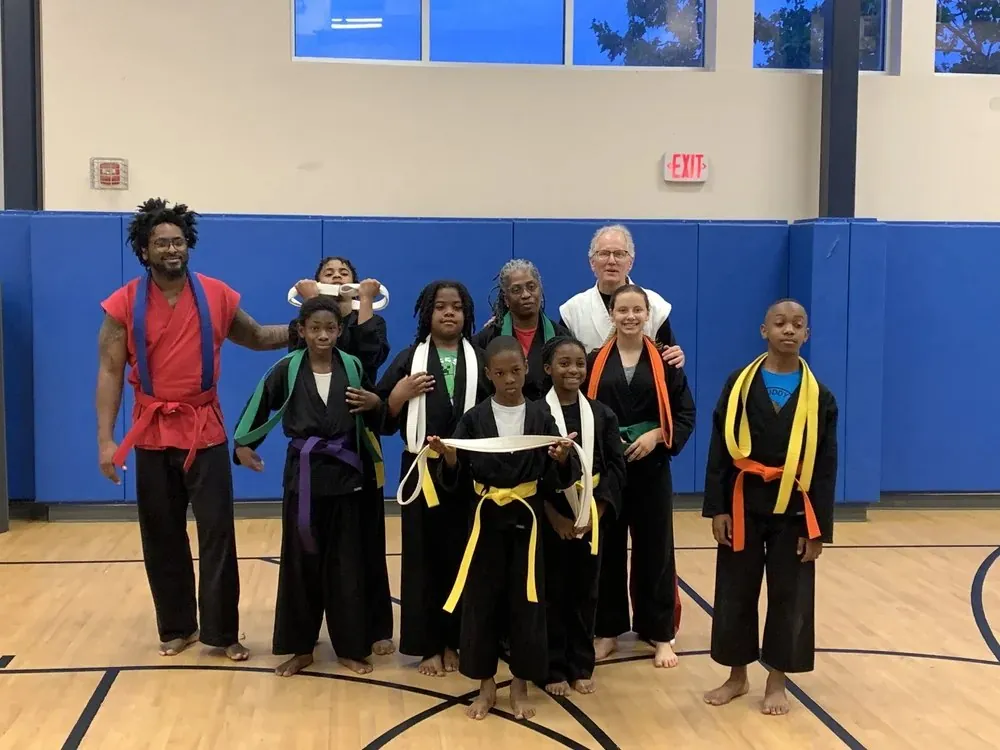 Young martial artists and mentors together after an activity